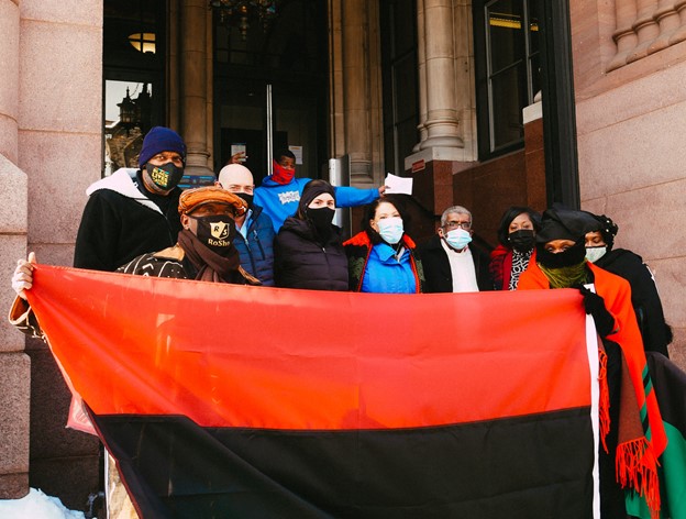 Attendees hold the flag.